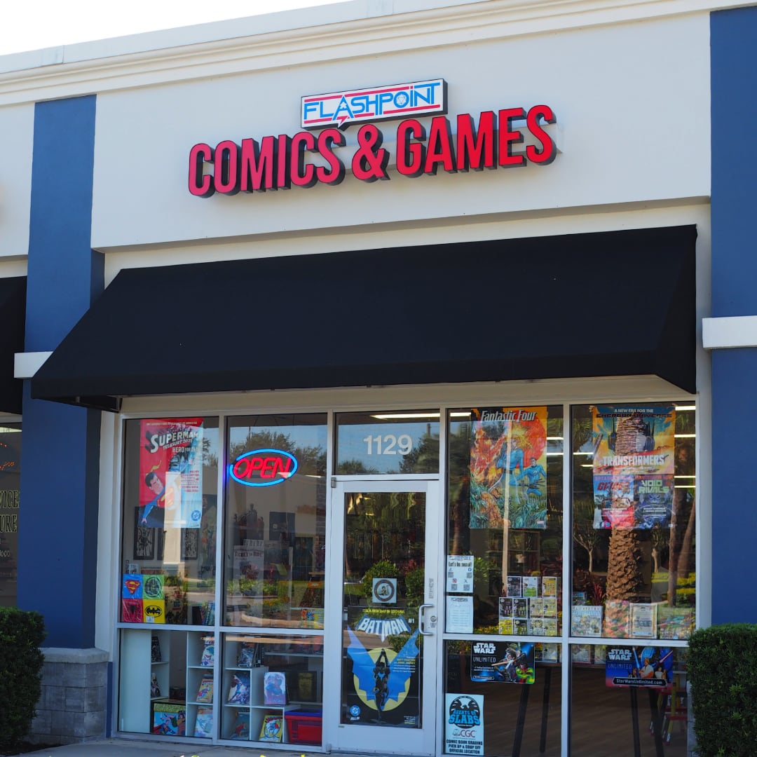 front of Flashpoint Comics and Games store with comic posters on windows and lit open sign